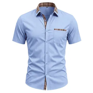 Close-up of light blue men's short sleeve shirt featuring a classic plaid collar detail