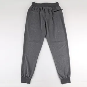 Back view of grey men's joggers featuring elastic waistband and rear zipper pocket detail.