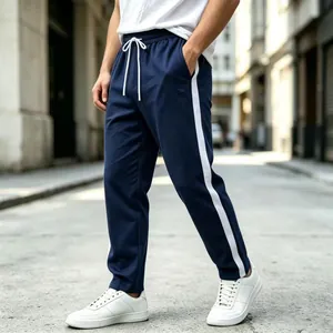 Detail of men's blue sweatpants with white side stripes and drawstring waist