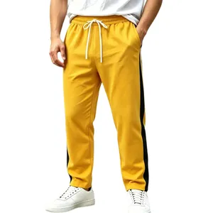 Men's bright yellow side-striped sweatpants with white drawstring and relaxed fit style