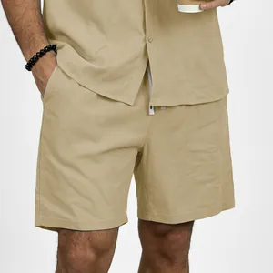 Close-up detail of men's casual beige linen shorts with drawstring elastic waist band