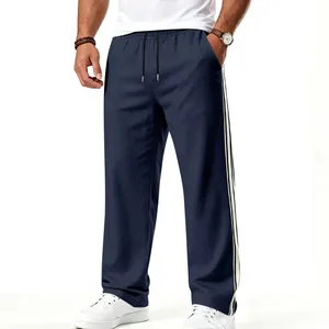 Men's loose navy sports trousers featuring white side stripes and drawstring waist