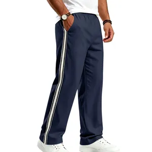 Detail view of men's loose navy blue sports pants featuring classic white side stripes