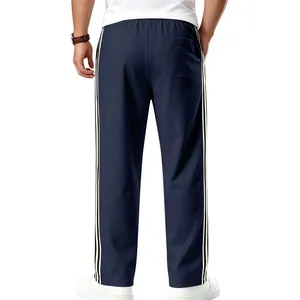 Back view detail of men's navy sports pants with three white side stripes