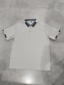 Detailed view of grey quick-dry sports polo shirt with color-block striped collar and size L tag