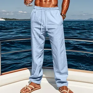 Close-up of men's breathable light blue linen trousers worn on a yacht deck