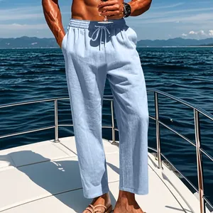 Men's light blue linen casual pants with drawstring waist shown on a yacht deck