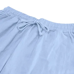 Close-up of light blue linen pants waistband with elastic band and drawstring