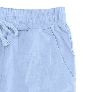 Detailed macro view of light blue linen pants with elastic waistband and drawstring