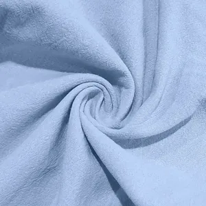 Macro view of light blue linen fabric texture for breathable loose fit mens trousers