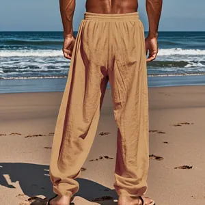 Back view of comfortable men's loose tan linen casual trousers on a sunny beach setting