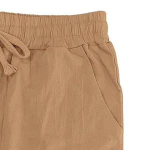 Detail of men's linen casual pants showing elastic waist, drawstring, and side pocket.
