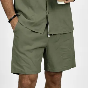 Detail view showing the olive green fabric and drawstring waist of men's linen shorts