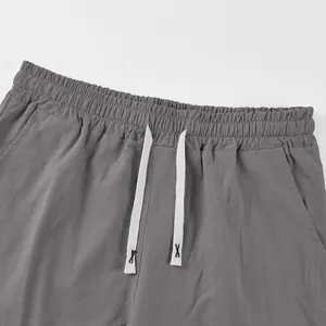 Detailed macro view of grey linen casual shorts with elastic waist and drawstrings