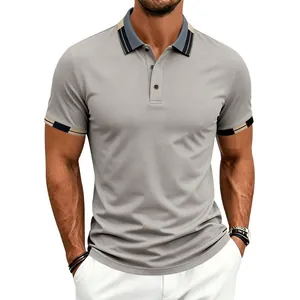 Close-up of gray men's polo shirt featuring navy and beige contrast collar and cuffs