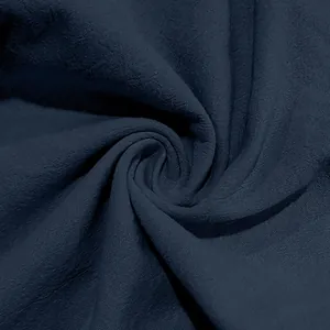 Detailed close-up of dark navy linen fabric texture showing breathable weave pattern