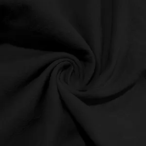 Detailed macro view showing the breathable texture of black linen fabric for men's pants