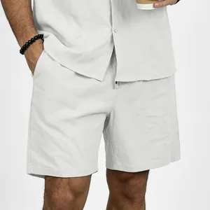 Close-up detail of men's breathable linen drawstring shorts in light grey beach style