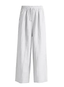 Detailed macro shot of men's white loose-fit linen trousers with drawstring waist.