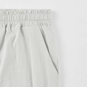 Detailed view of elasticated waistband and pocket on men's linen shorts