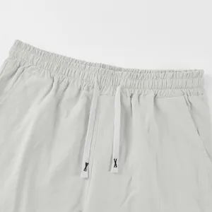 Detail shot of the elastic waistband and textured drawstring on men's casual linen shorts