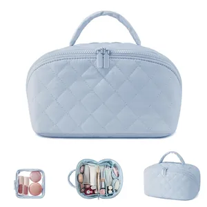 Light blue quilted cosmetic bag, large capacity travel organizer pouch with zipper and handle.