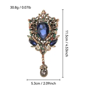 Vintage palace style brooch with blue teardrop crystal and rhinestone accents