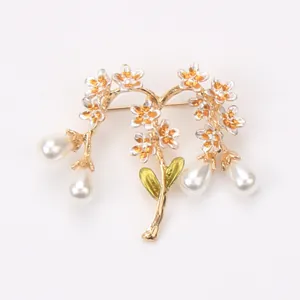Detailed vintage floral branch brooch featuring white flowers, green leaves and teardrop pearls