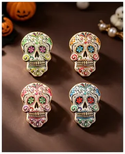 Macro view of four colorful Mexican sugar skull brooches with enamel and floral patterns