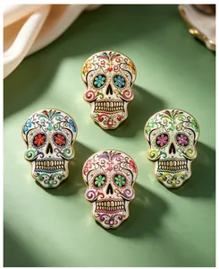 Close-up of colorful enamel sugar skull brooches for Day of the Dead party costumes.