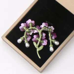 Detailed back view of a vintage floral branch brooch with pearl drops in a gift box