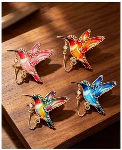 Detailweergave van kleurrijke emaille kolibrie broches met kristallen strasstenen