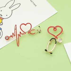 Detailed close-up of creative heart stethoscope enamel brooches for doctor and nurse gifts