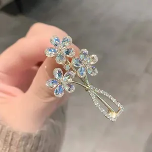 Detailed view of crystal flower vase brooch with sparkling rhinestones