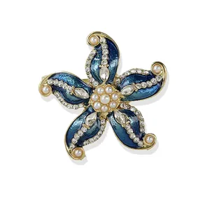 Vintage starfish brooch with blue enamel inlay, sparkling crystals, and white pearls