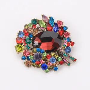 Close-up detail of vintage gold-toned alloy brooch with multicolored crystal rhinestones