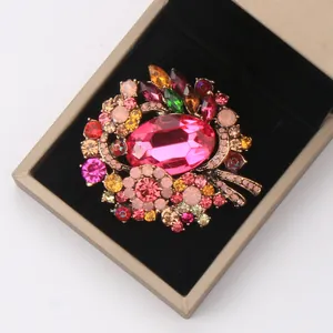 Elegant macro view of a colorful crystal alloy brooch inside a golden jewelry gift box