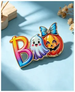 Detail of cute Halloween ghost and pumpkin enamel pin with "BOO" lettering.