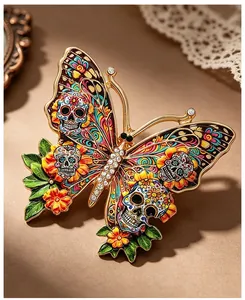 Close-up of colorful butterfly brooch with sugar skull patterns and crystal details.