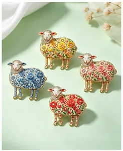 Detailed view of four vintage floral sheep brooches with colorful enamel and crystals.
