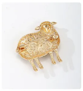 Detailed back view of a vintage golden sheep brooch with intricate floral textures