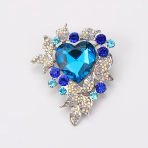Macro detail view of luxury Heart of the Ocean brooch featuring vibrant blue crystals