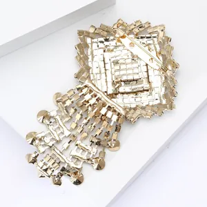 Detailed back view of elegant golden rhinestone tassel brooch showing secure pin closure