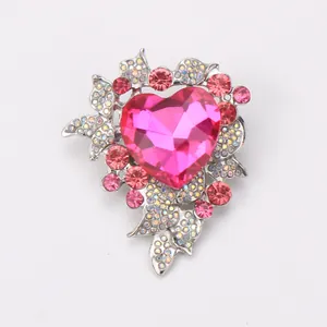 Detailed macro shot of a luxurious pink heart crystal brooch with sparkling rhinestones.