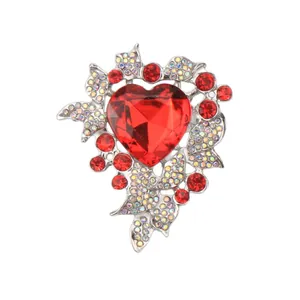 Elegant silver alloy heart brooch featuring luxury red rhinestones and iridescent gems