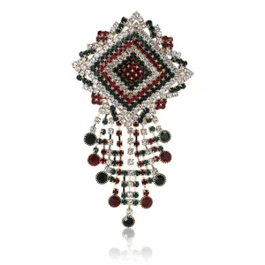 Elegant vintage crystal rhinestone brooch pin featuring red and green gems with dangles