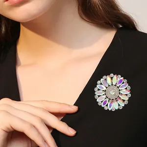Macro detail of a vintage floral brooch with iridescent AB rhinestones on a black dress
