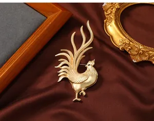 Detailed view of a vintage matte gold rooster brooch for men's suit jacket lapels.