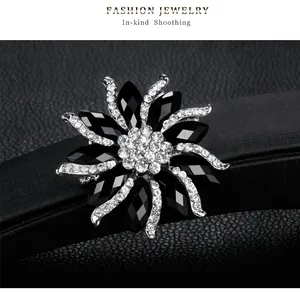 Detailed view of elegant black and silver sunflower brooch with crystal rhinestones