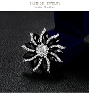 High-end crystal flower brooch detail with elegant black rhinestones on silver base